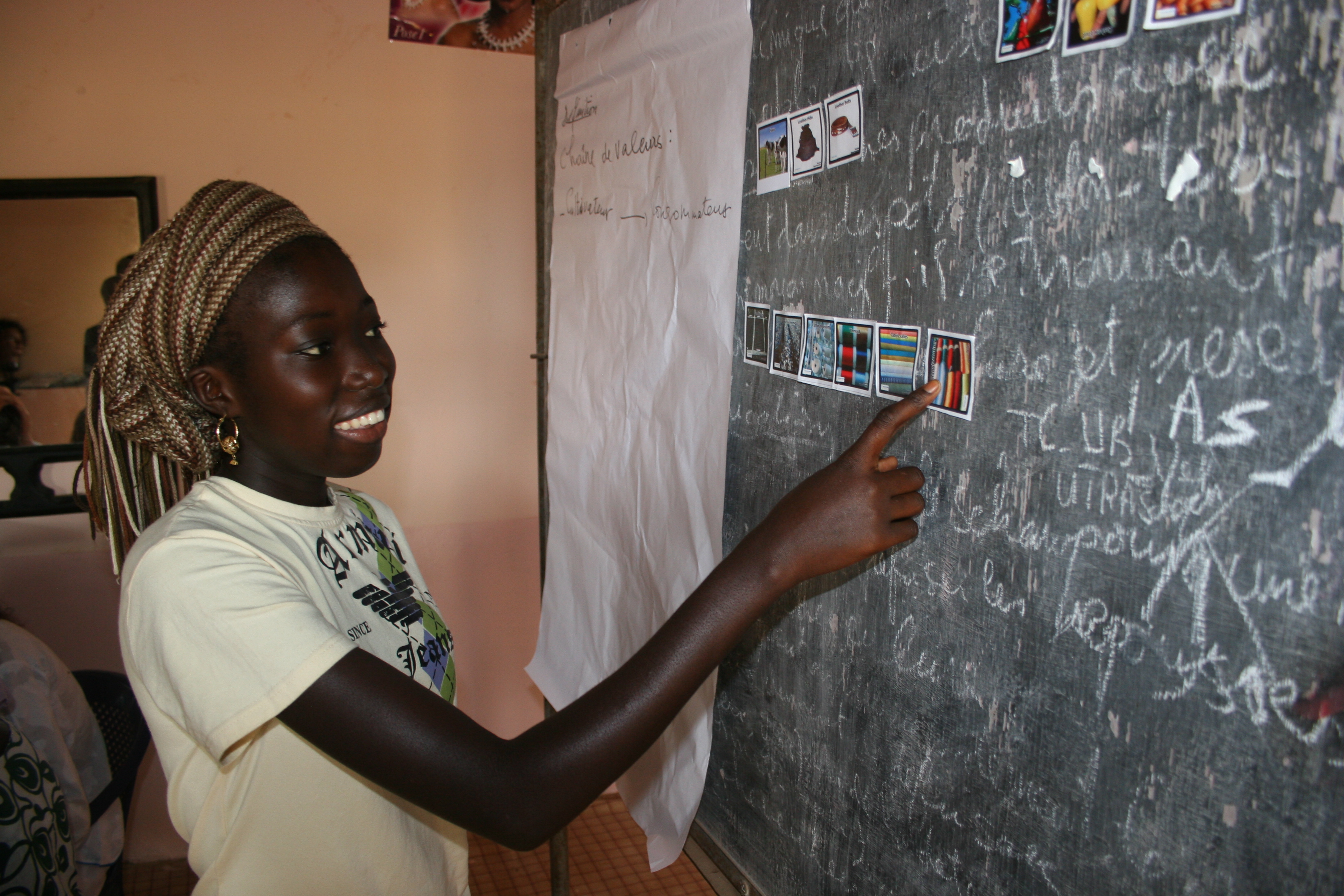 Photo of adolescent girl working on blackboard at school 