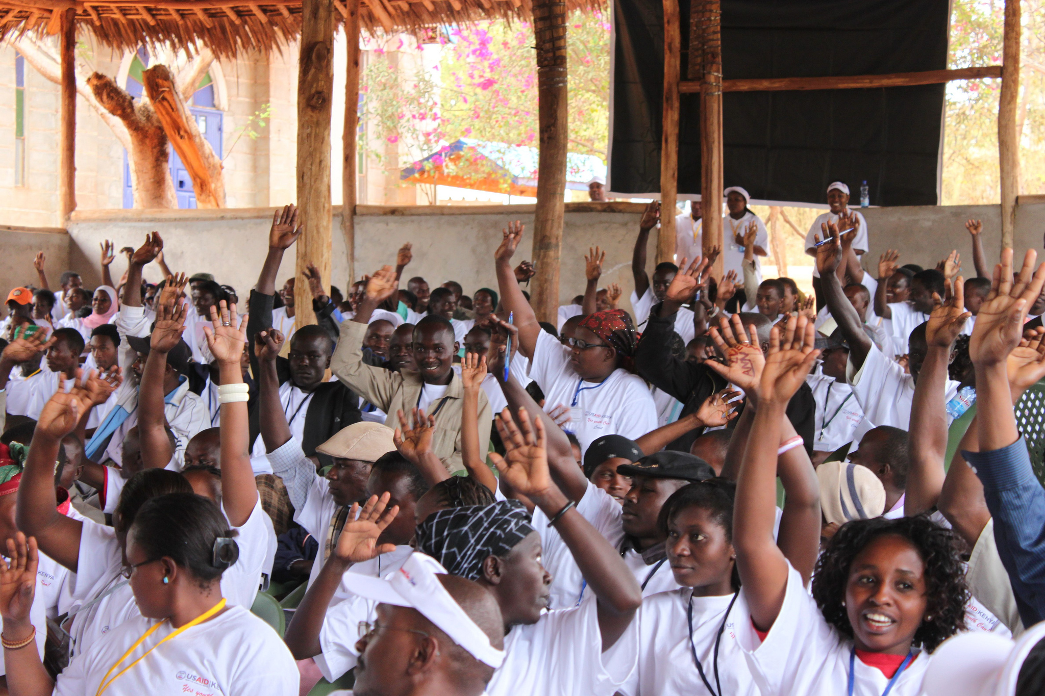 Young people are raising hands. A Model Democracy For Kenyan Youth, Photo by Donatella Lorch, USAID